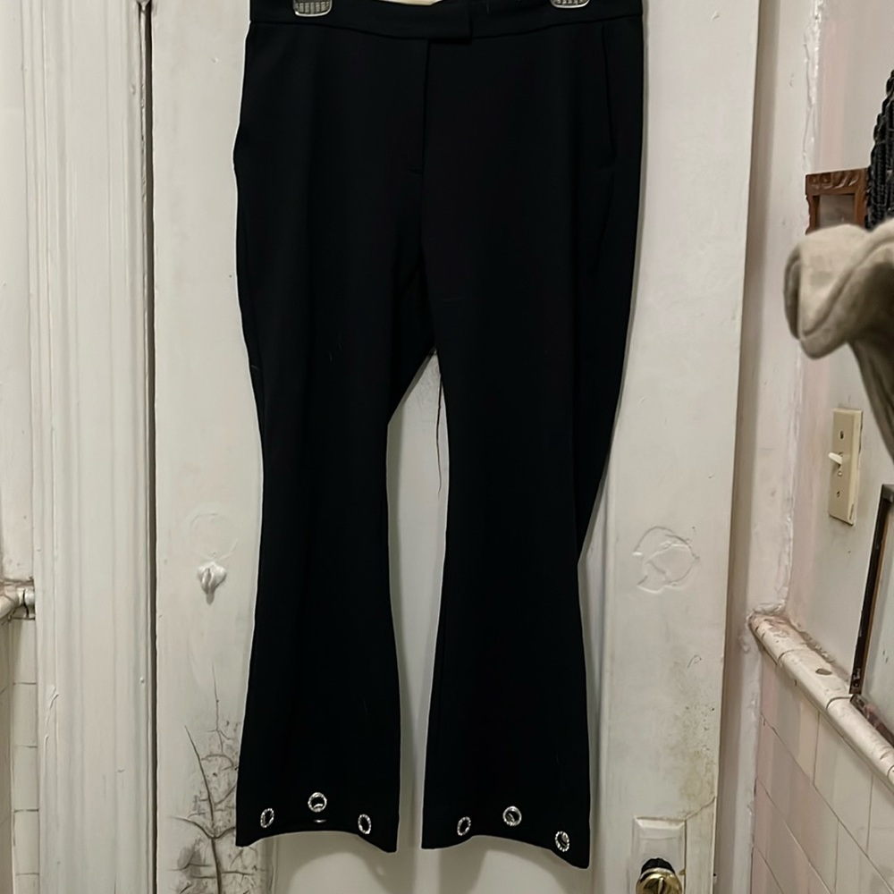 Michael Michael Kors black pants with rhinestone grommets on the hem.